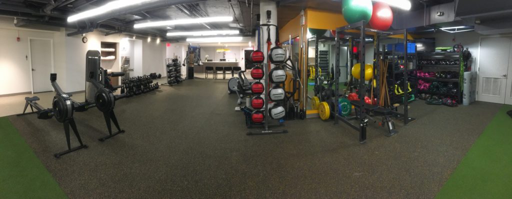 Training floor at Momentum Fitness with rowers, medicine balls, kettlebells, and conditioning equipment